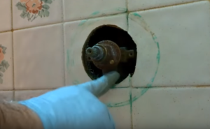 leak behind shower wall